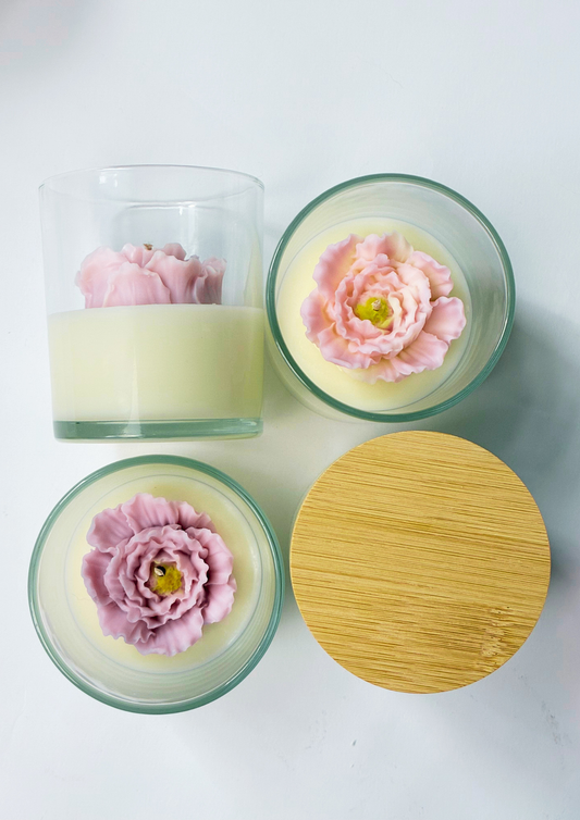 Candle in a floral glass jar with a bamboo lid